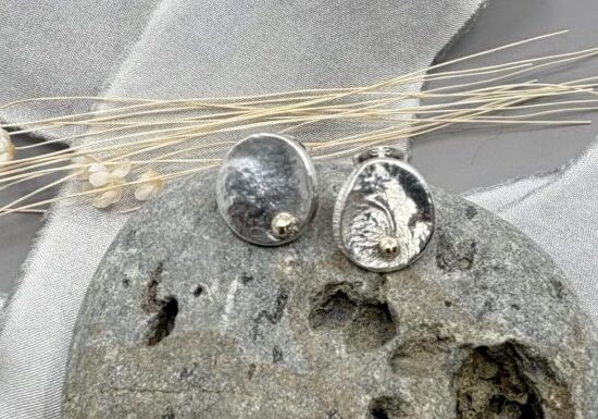 recycled silver circle stud earrings with organic textures and recycled gold detail
